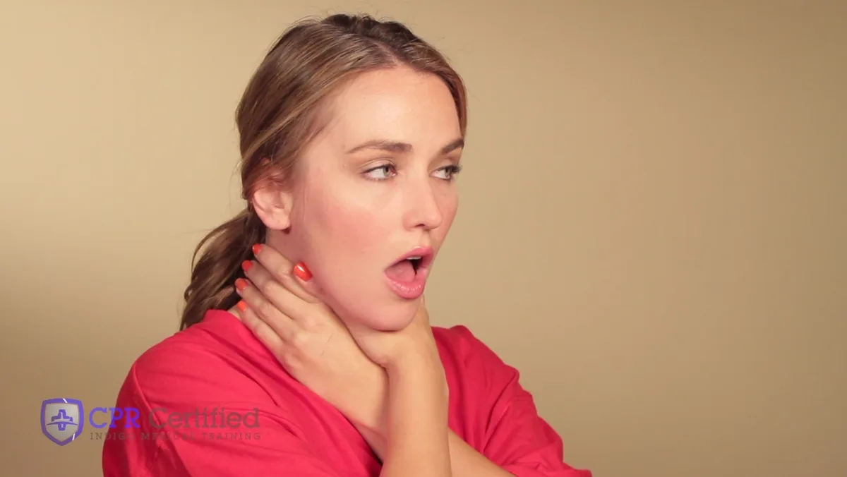 A woman with both hands at her throat, mouth open, unable to speak.